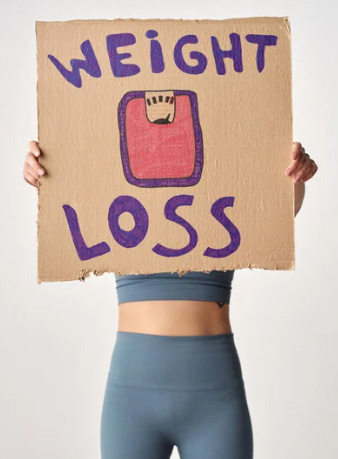 Woman holding a sign that says Weight Loss
