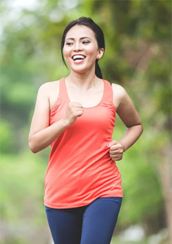 a woman jogging and smiling